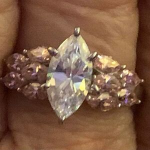Pretty marquis solitaire with pink accents stones. Size 8 rhodium over silver